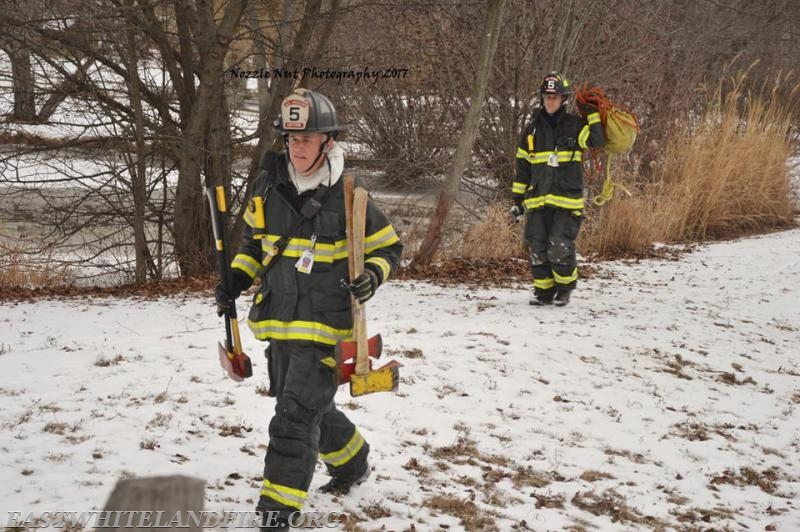 Returning equipment to the engine after horse rescue, EW Career Captain Mike Risell and EW FF Jason Legieko. Photo courtesy of Nozzle Nut Photography.
